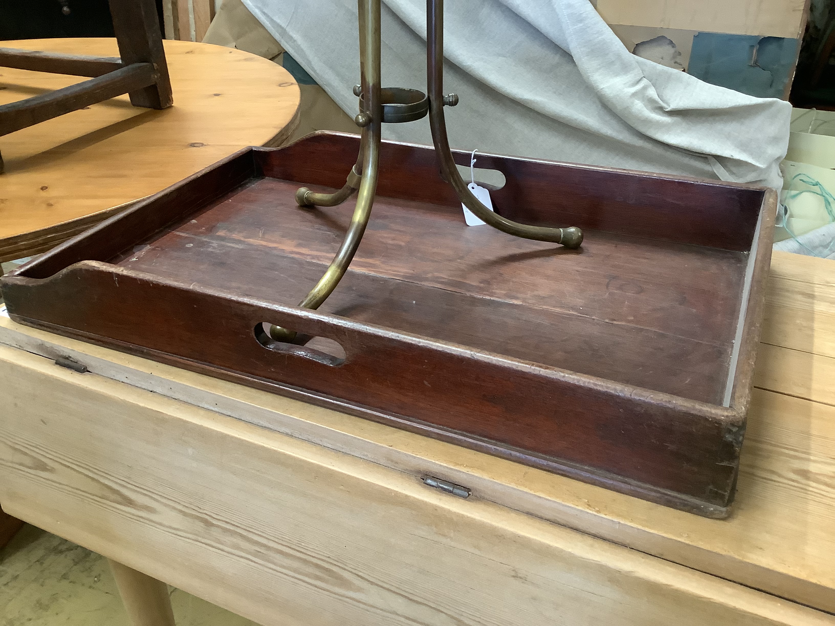 A brass framed tripod magazine stand together with a Victorian mahogany butler's tray, width 67cm, depth 42cm